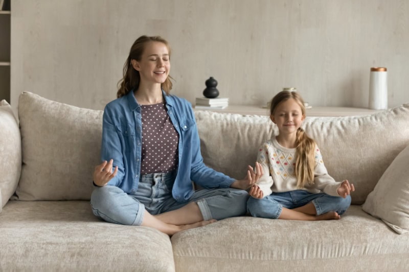 Sisters meditating thanks to a quiet air conditioning unit.