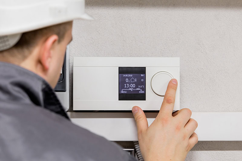 Technician running through spring air conditioning maintenance in Houston.