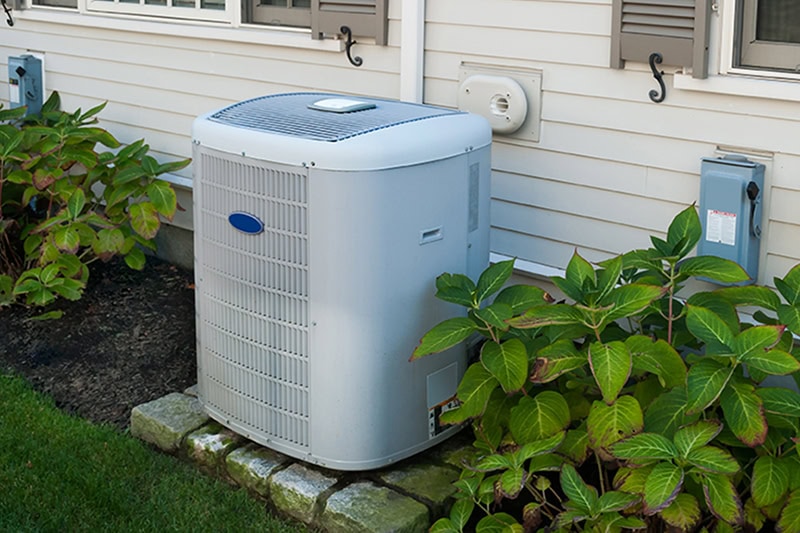 Why Is My AC Short Cycling? Photo of an HVAC Unit installed outside of a home.